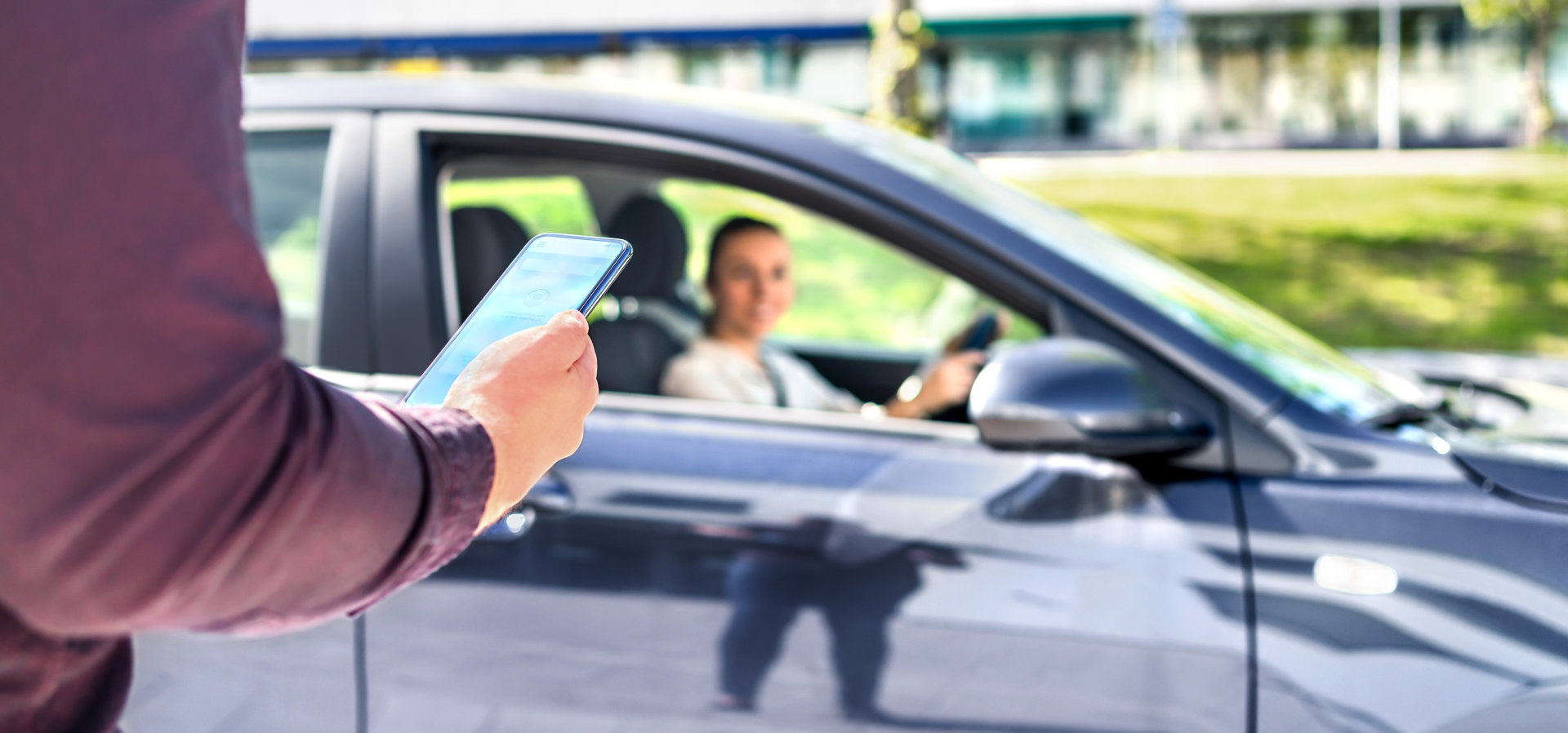 man holding a phone while waiting for a driver