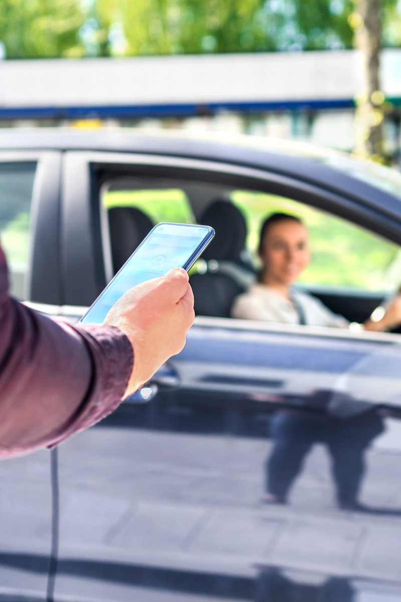 man holding a phone while waiting for a driver